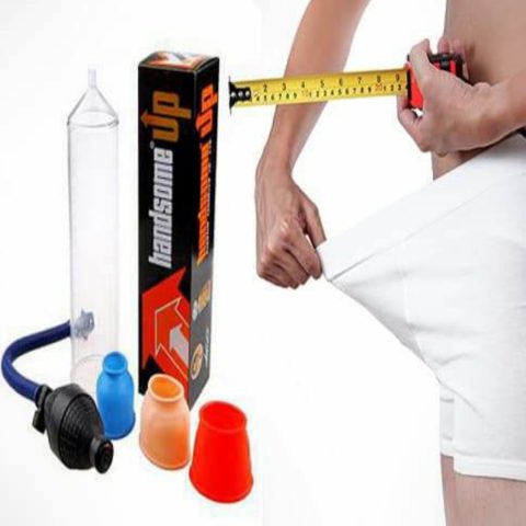 Handsome Up male enhancement vacuum pump set displayed with different sized silicone sleeves, a hand pump, and measuring tape being used by a man wearing white shorts to illustrate size measurement for male enlargement use